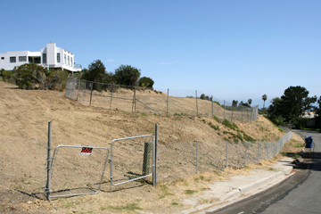 RS Family Partnership plans to build four homes off Via Santa Ynez (above). The property is the location of a 1966 slide that demolished two homes on Enchanted Way and tore up the street of Via Santa Ynez. The white house pictured was rebuilt a few years ago on one of the slide lots, which had only partially slipped.